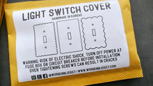 Load image into Gallery viewer, a close up of a light switch cover
